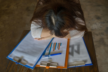Overworked employee fall asleep on deadline reports