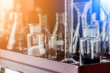 laboratory glass bottle in wood tray