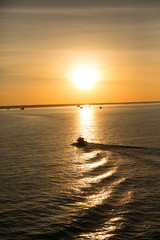 Dawn, boat on the ocean