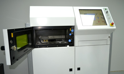 Laser sintering machine for metal. Open working chamber of a laser sintering machine for metal. Overall plan. 3D printer printing metal. Modern additive technologies 4.0 industrial revolution