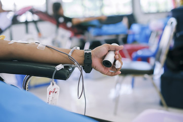 Blood donor at donation with a bouncy holding in hand