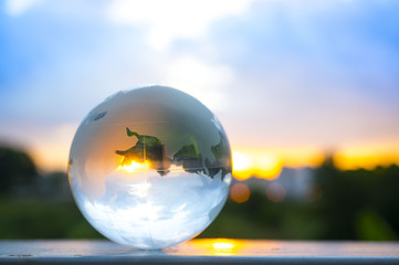 Transparent globe with sunset background