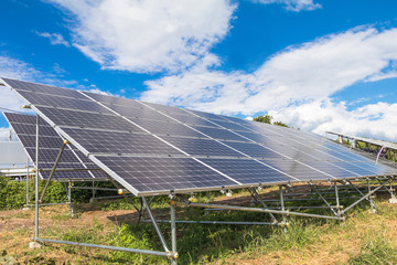 Solar  power panels for innovation green energy for life with mountains and blue sky background.