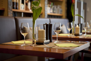 indesign in a nice restaurant with a nice table and spirits in the background wall rack