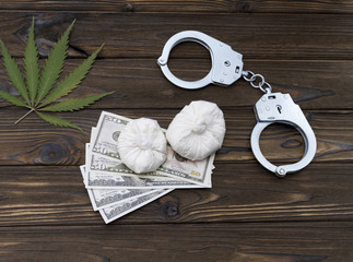 Marijuana, heroin, dollar bills, handcuffs. drugs, crime. marketing. sale. Spread.