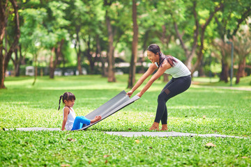 Positive mother and her little daughter going to enjoy sport in the park