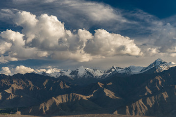 Landscape of Mountain  Everest Range Peak with dramatic clouds, blue sky and strong sunlight.