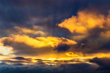 Fototapeta na wymiar rays of the sun make their way through dramatic clouds