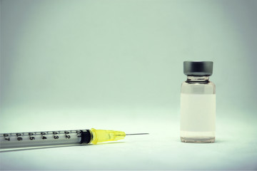 Medical syringe and dose bottle used in medicine. Medical part concept.