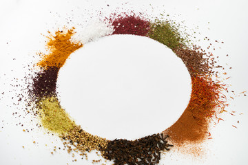 Circle frame composition of spices and herbs isolated on white