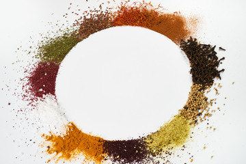 Colorful circle frame of spices and herbs isolated on white