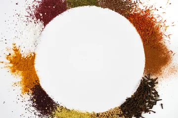 Keuken spatwand met foto Colorful circle frame of spices and herbs isolated on white © Gecko Studio