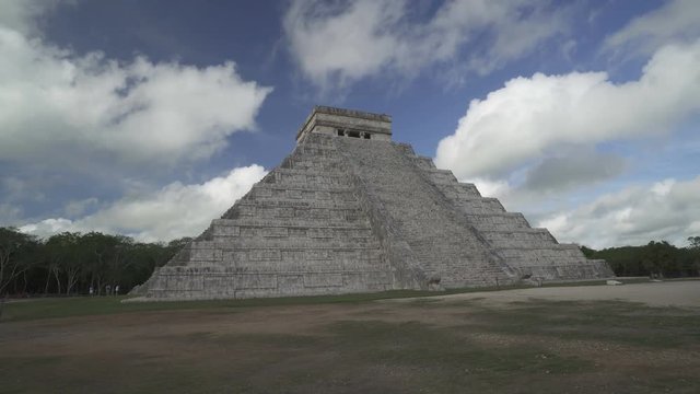 CHICHEN ITZA, MEXICO - MAY 25, 2017: Movement along Maya pyramid temple of Kukulkan in Mexico on the background at cloudy blue sky
