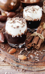 hot chocolate in glass cups and cream with nuts