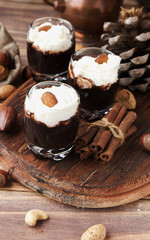 hot chocolate in glass cups and cream with nuts