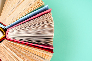 Top view of bright colorful hardback books in a circle.