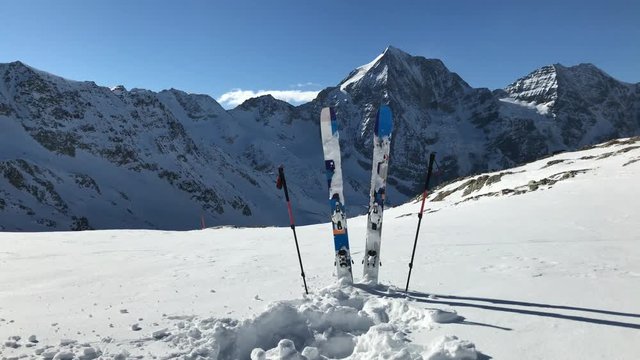 Ski in winter season, mountains and ski touring backcountry equipments on the top of snowy mountains in sunny day. South Tirol, Solda in Italy.
