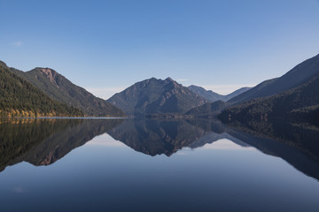 Fototapeta na wymiar Reflection on water Lake Crescent located 18 miles west of Port Angeles in the Olympic mountain foothills of Olympic National Park, Washington