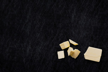 Organic Butter isolated on a scratched slate chopping board. Horizontal composition. Top view