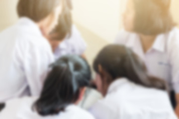 Obraz premium blurred of group of students in Thailand wear school uniforms sitting in line for school activities in morning, Education Concept methods contemporary educational comprises formal systems in Asia.