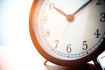Closeup of Retro alarm clock with twelve o'clock. Time is indefinite continued progress of...