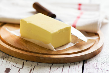 Butter block on wooden board. Baking or cooking concept