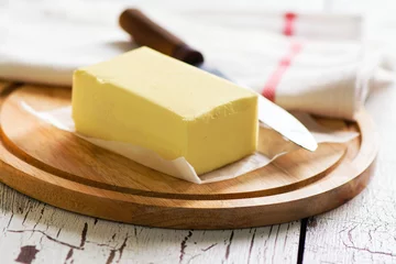 Gordijnen Butter block on wooden board. Baking or cooking concept © happy_lark