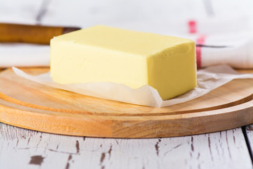 Butter stick on wooden board. Baking or cooking concept