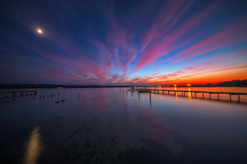 Wooden Dock and fishing boat at the lake, sunset shot