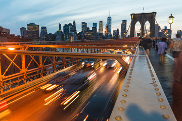 Brooklyn bridge with traffic and people in New York