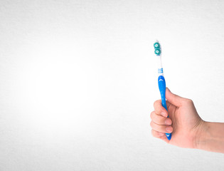 toothbrush or toothbrush in hand on background.