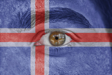 Human face and eye painted with flag of Iceland