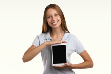 Young attractive woman holding a tablet. Casual girl. Smiling portrait. Beautiful  woman.  Studio shot.