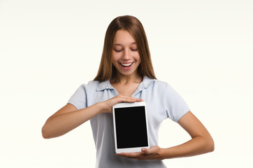 Young attractive woman holding a tablet. Casual girl. Smiling portrait. Beautiful  woman.  Studio shot.