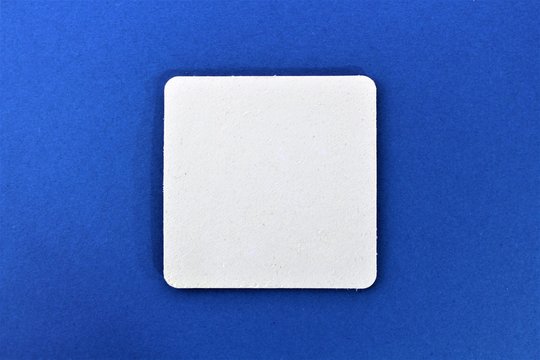 An image of beermat, with blue background