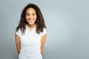 Positive delighted international girl looking at camera