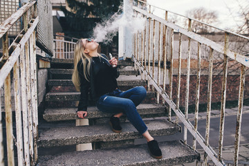 Vaping. Young beautiful woman vaping . Vapor concept.