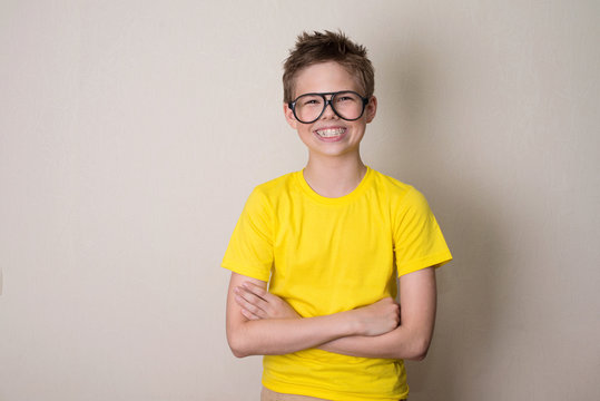 Health, education and people concept. Happy teen boy in braces and eyeglasses smiling.