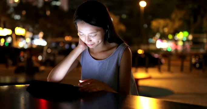 Asian Woman use of tablet computer at night