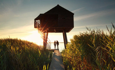 couple by wooden observing tower