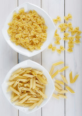 Two types of pasta on a white plate. 