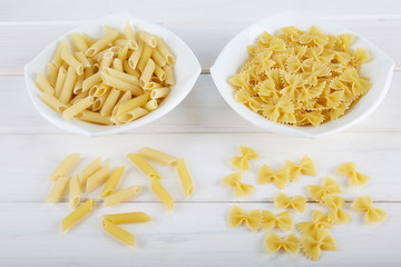 Two types of pasta on a white plate. 