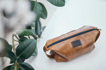 Brown cosmetic bag on white background