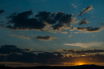 Natural Sunset Sunrise Over Field Or Meadow. Bright Dramatic Sky And Dark Ground.