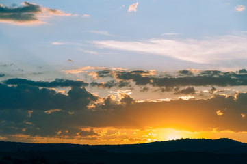 Natural Sunset Sunrise Over Field Or Meadow. Bright Dramatic Sky And Dark Ground.