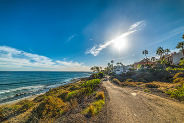Sun shining over Malibu shoreline - obrazy, fototapety, plakaty