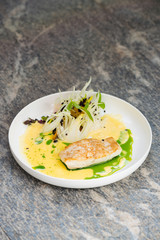 Fine dining, white fish fillet breaded in herbs and spice with shrimps and vegetables