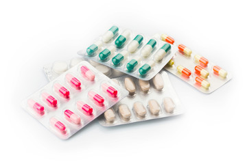 Various pills  and Capsules on the White Surface
