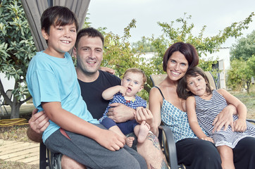 Big family. Parents with three children outdoors. Two daughters and one son.