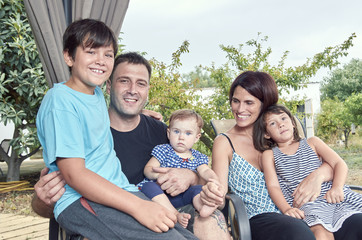 Big family. Parents with three children outdoors. Two daughters and one son.